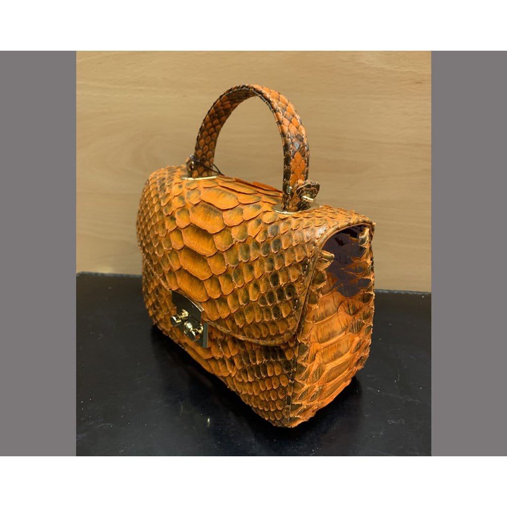 Small real python top handle bag, orange, side