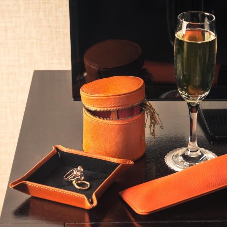 Small leather valet tray, orange with black, lifestyle