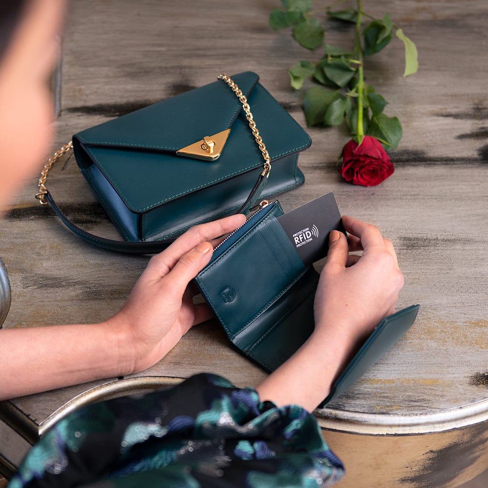 RFID blocking leather envelope purse, petrol green, lifestyle view