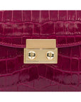 Small leather top handle bag, pink croc, lock close up