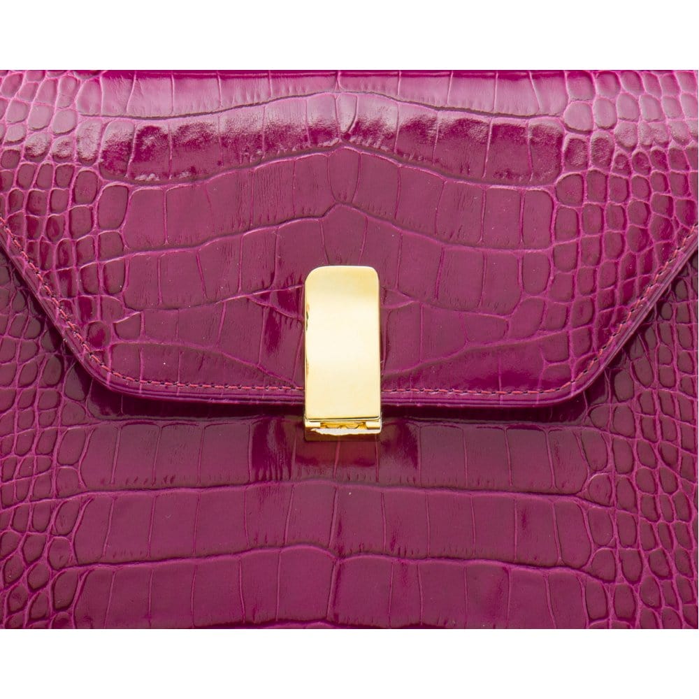 Leather top handle bag, pink croc, lock closeup