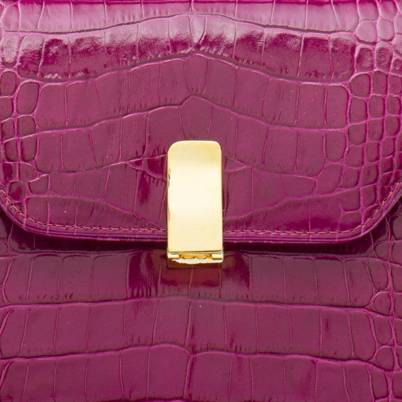 Leather top handle bag, pink croc, lock closeup