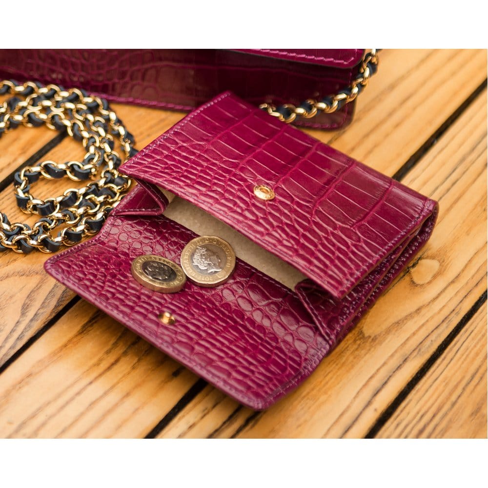Leather purse with brass clasp, pink croc, lifestyle