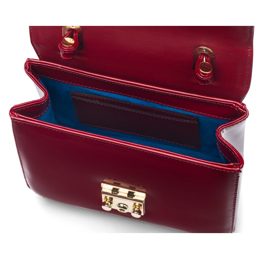 Small leather top handle bag, red patent, inside