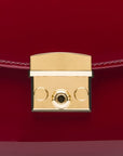 Small leather top handle bag, red patent, lock close up