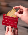 Flat leather credit card holder with middle pocket, 5 CC slots, red croc, lifestyle view