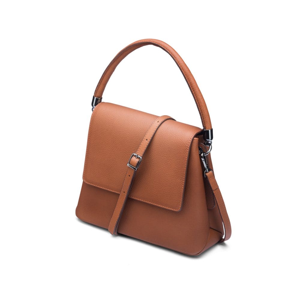 Leather handbag with flap over lid, tan, side view