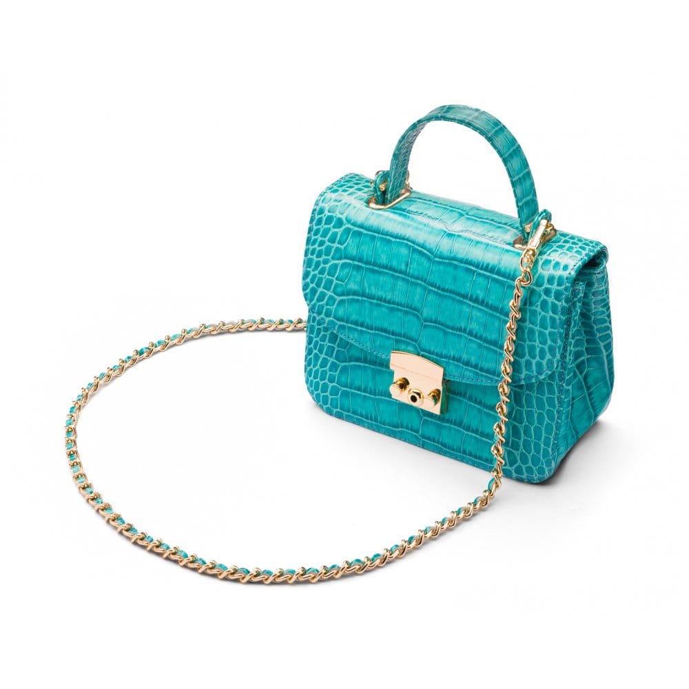 Small leather top handle bag, turquoise croc, side