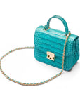 Small leather top handle bag, turquoise croc, side