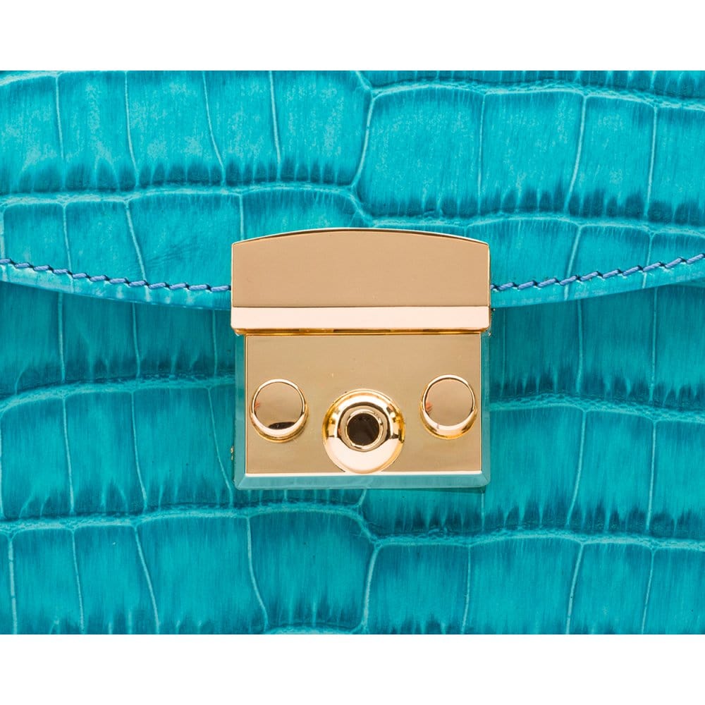 Small leather top handle bag, turquoise croc, lock close up