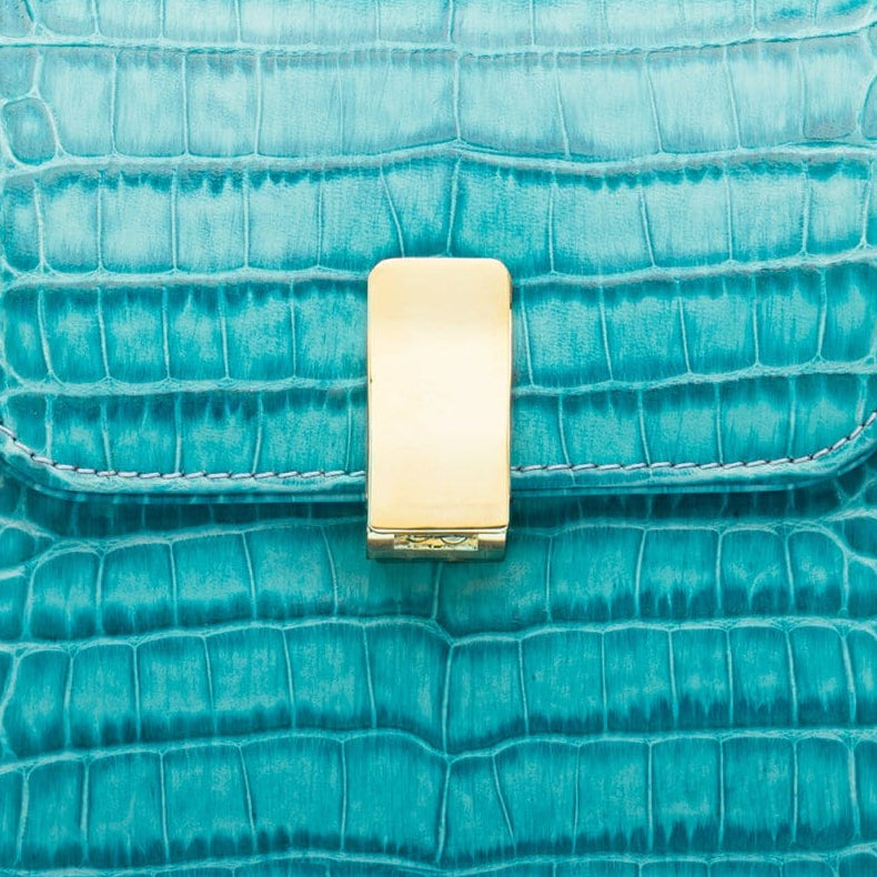 Leather top handle bag, turquoise croc, lock closeup