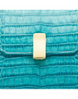 Leather top handle bag, turquoise croc, lock closeup