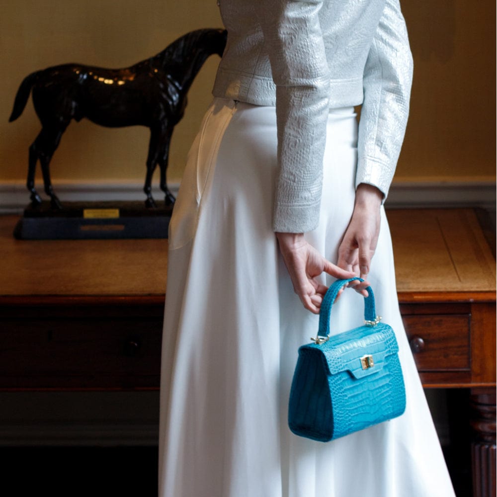 Mini leather Morgan Bag, top handle bag, turquoise croc, lifestyle