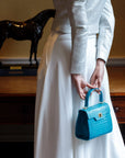 Mini leather Morgan Bag, top handle bag, turquoise croc, lifestyle