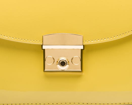 Small leather top handle bag, yellow patent, lock close up
