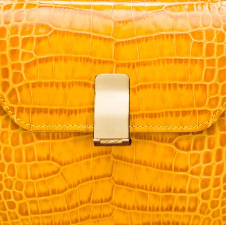 Leather top handle bag, yellow croc, lock closeup
