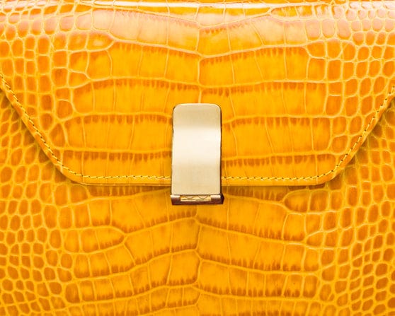 Leather top handle bag, yellow croc, lock closeup